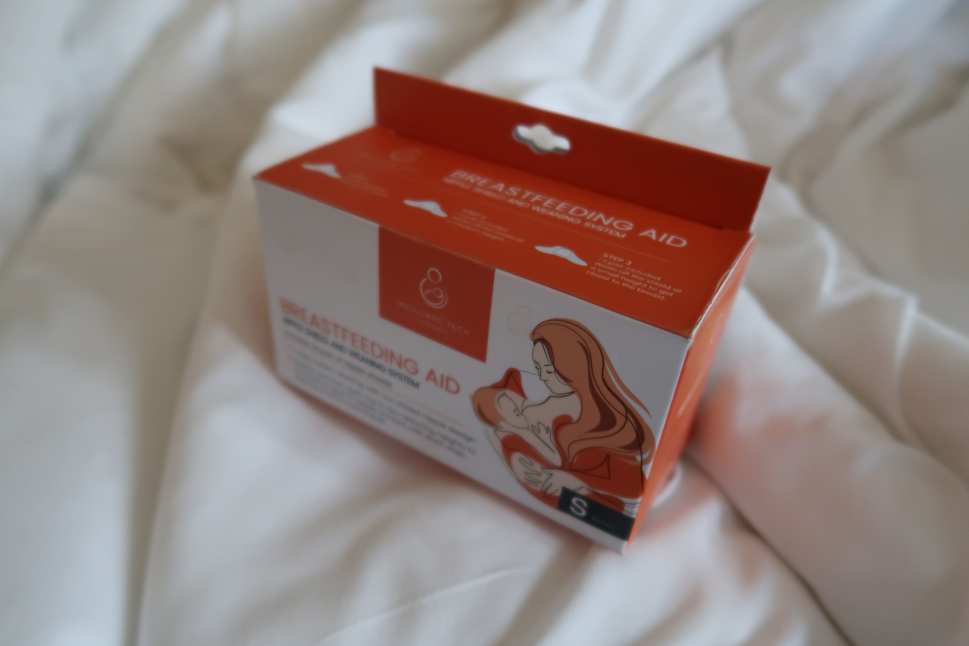 Box of breastfeeding aid on a white surface